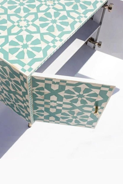 Seafoam green bone inlay four-door sideboard with all doors open showing two interior shelves on each side and brass legs