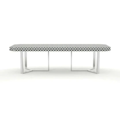 Geometric bone inlay dining table with intricate black and white pattern and stainless steel cross-frame base on white background