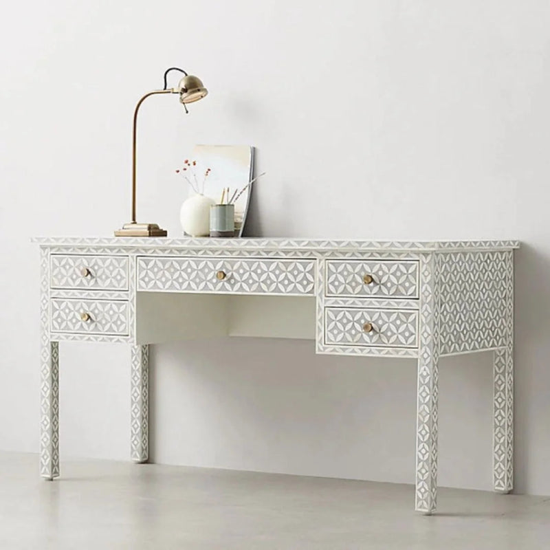 Handmade bone inlay geometric writing desk with 5 drawers and brass hardware, featuring an all-over diamond motif in grey and white, styled with a gold desk lamp and vase