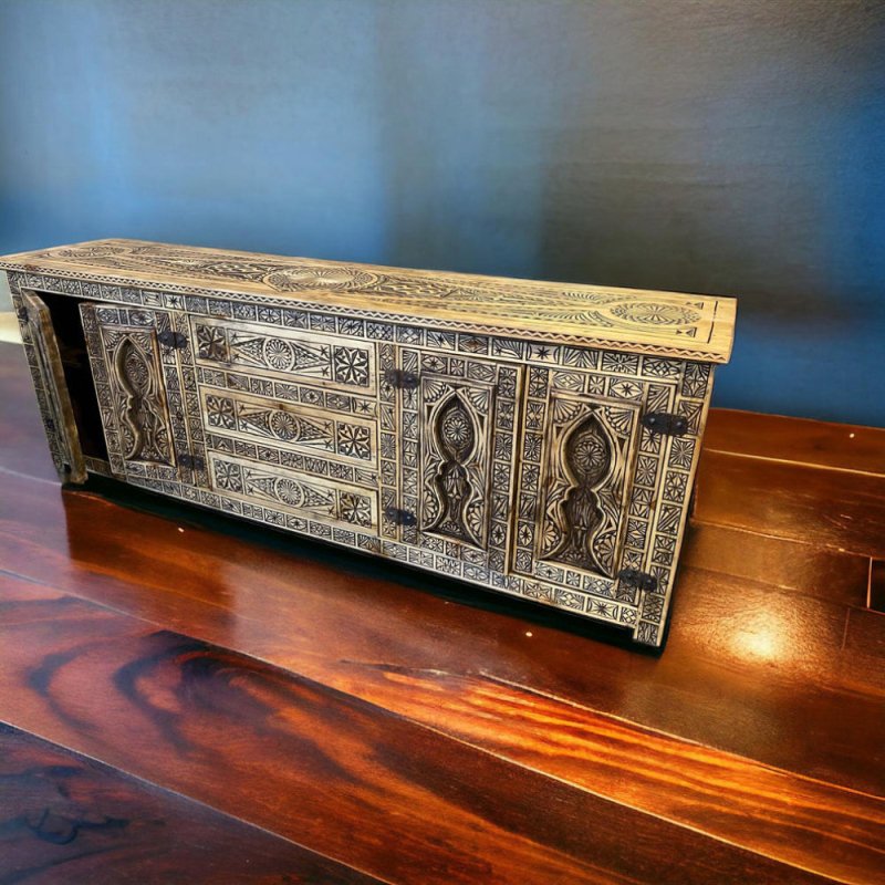 Geometric carved wood credenza in rustic timber, elevated front view against a blue wall on polished wood flooring.