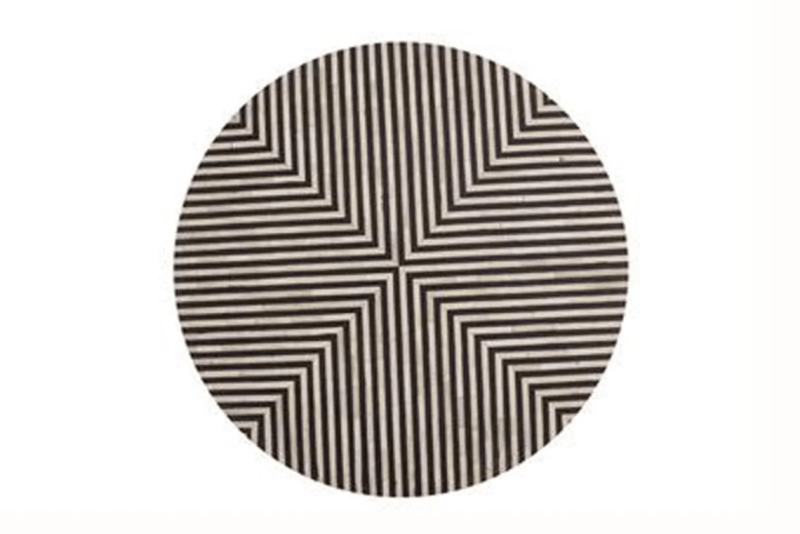Overhead flat lay of a geometric black and white stripe bone inlay round table top showing symmetrical radial stripe pattern crafted by Indian artisans using traditional bone inlay technique