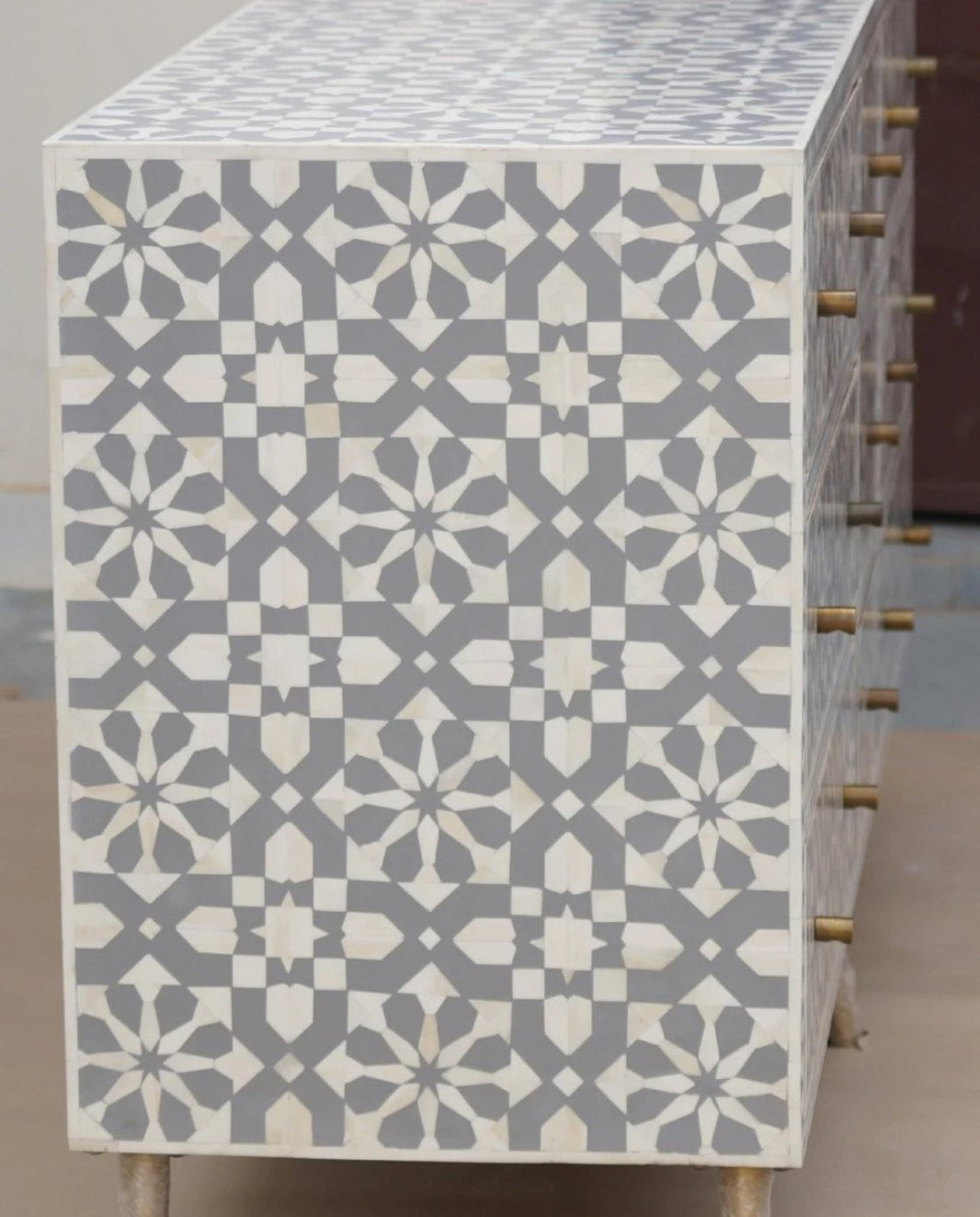 Gray bone inlay lowboy with Moroccan geometric inlay, front-facing view of the custom-made nine-drawer storage chest