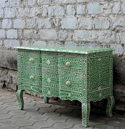 Emerald green bone inlay 2-drawer French dresser with dense floral vine inlay, ivory flower knobs, and scalloped base, styled in a Parisian-inspired room with mirror and decor accents – handcrafted luxury furniture.