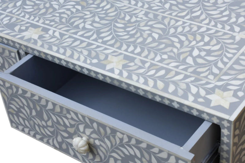 Open drawer of handmade grey bone inlay console table showing deep storage space and intricate floral white bone inlay pattern on surface