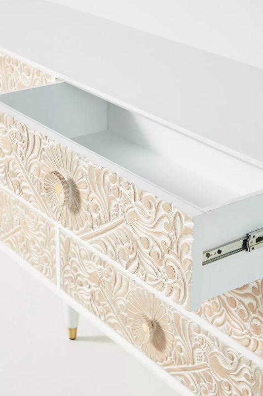 The Gulliver chest of drawers , showing the open drawer with textured carving across six drawer faces.