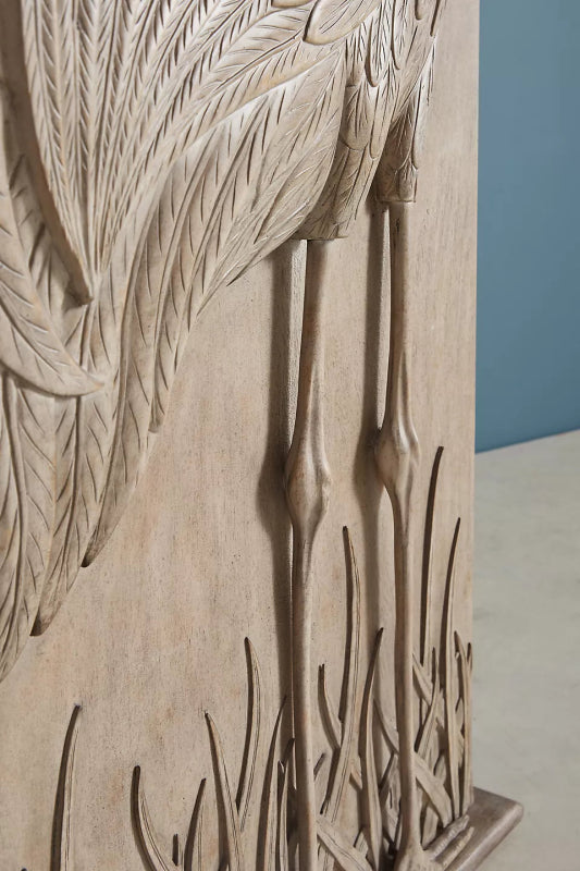 Hand-Carved Crane Wardrobe in a light wood finish, close-up of feather carving, long legs, and marsh grass.