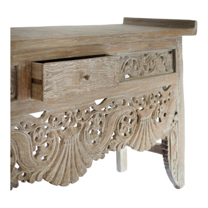 Hand-carved rustic floral accent table, close-up of scrollwork apron and leg detail.