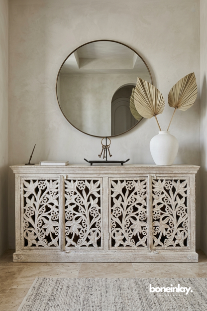 Hand-carved floral sideboard with openwork botanical panels, soft whitewashed finish, and refined artisanal craftsmanship.