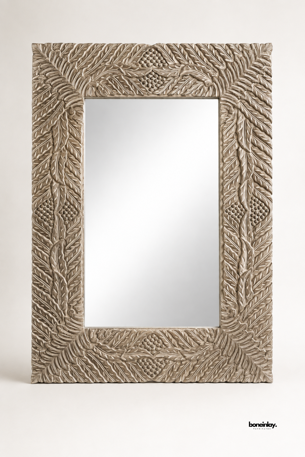 Large rectangular wall mirror framed in whitewashed solid wood with a detailed feather and leaf carving pattern. Corner diamond motifs add texture and dimension to the wide decorative border. A statement mirror designed to bring rustic elegance to living rooms, bedrooms, or hallways. Handcrafted finish gives each piece a unique, one-of-a-kind character.