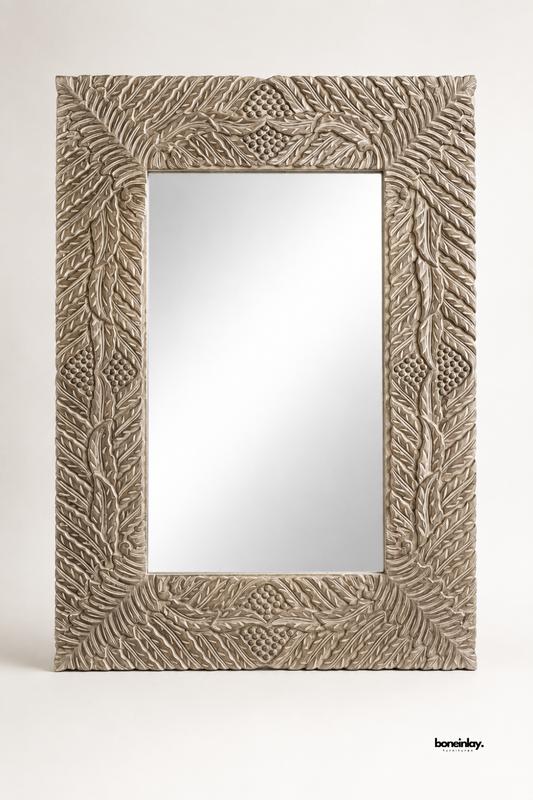 Large rectangular wall mirror framed in whitewashed solid wood with a detailed feather and leaf carving pattern. Corner diamond motifs add texture and dimension to the wide decorative border. A statement mirror designed to bring rustic elegance to living rooms, bedrooms, or hallways. Handcrafted finish gives each piece a unique, one-of-a-kind character.