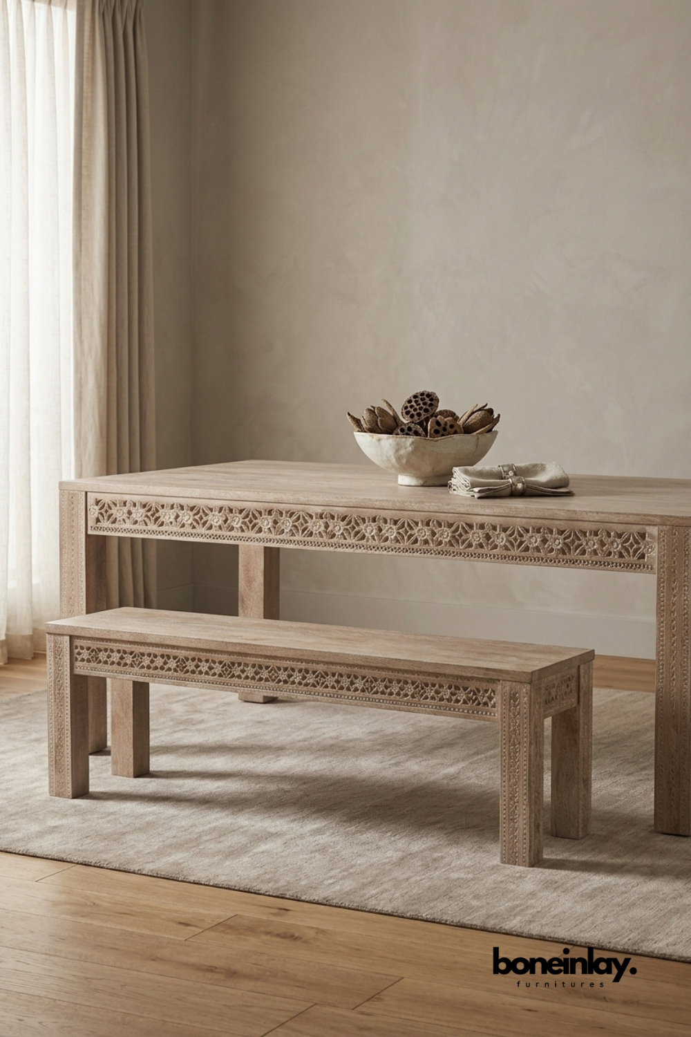 Hand carved solid wood dining table with intricate floral detailing and matching wooden bench in a natural wood finish.
