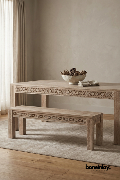 Hand carved solid wood dining table with intricate floral detailing and matching wooden bench in a natural wood finish.