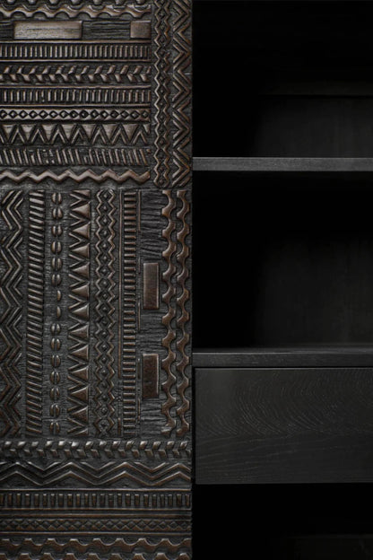 Hand-carved two-door cupboard in a detail view.