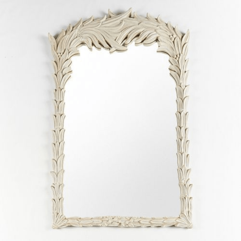 Hand-carved wood accent mirror with a rustic finish, front view showing an ornate leafy crest and slender frame.