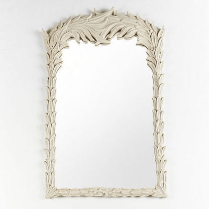 Hand-carved wood accent mirror with a rustic finish, front view showing an ornate leafy crest and slender frame.