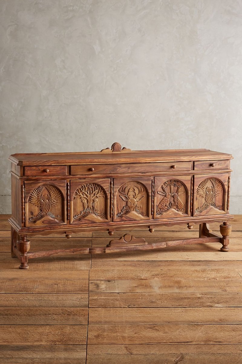 menagerie Hand-Carved Wooden Buffet in a natural finish, front view showing owl, deer, and tree carvings beneath three drawers.