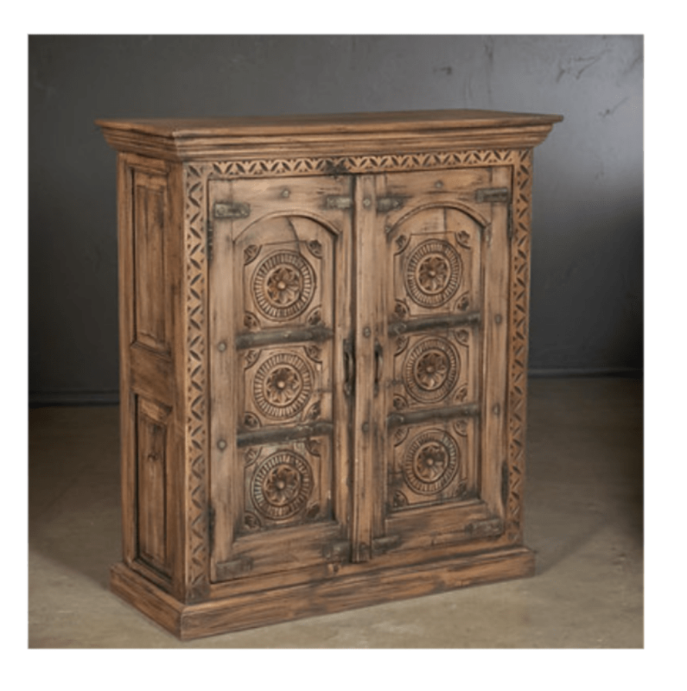 Hand-carved wooden buffet in natural brown tone, close-up of carved door panel detail.