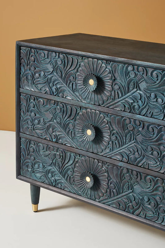 Close-up of the Gulliver wood dresser, showing the hand-carved texture on its drawer front.