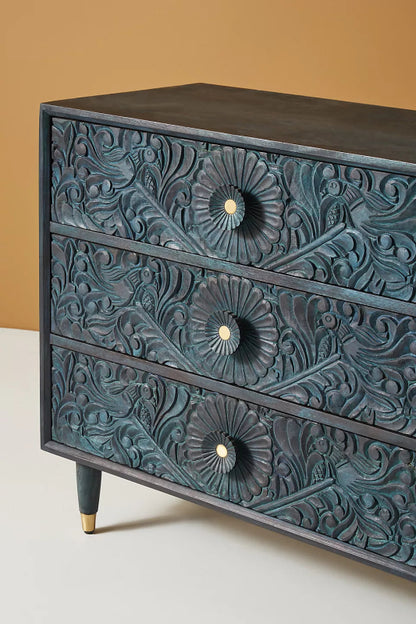 Close-up of the Gulliver wood dresser, showing the hand-carved texture on its drawer front.