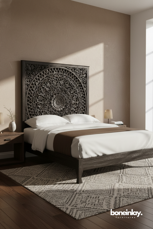 Black carved wood bed featuring circular mandala headboard and handcrafted detailing.
