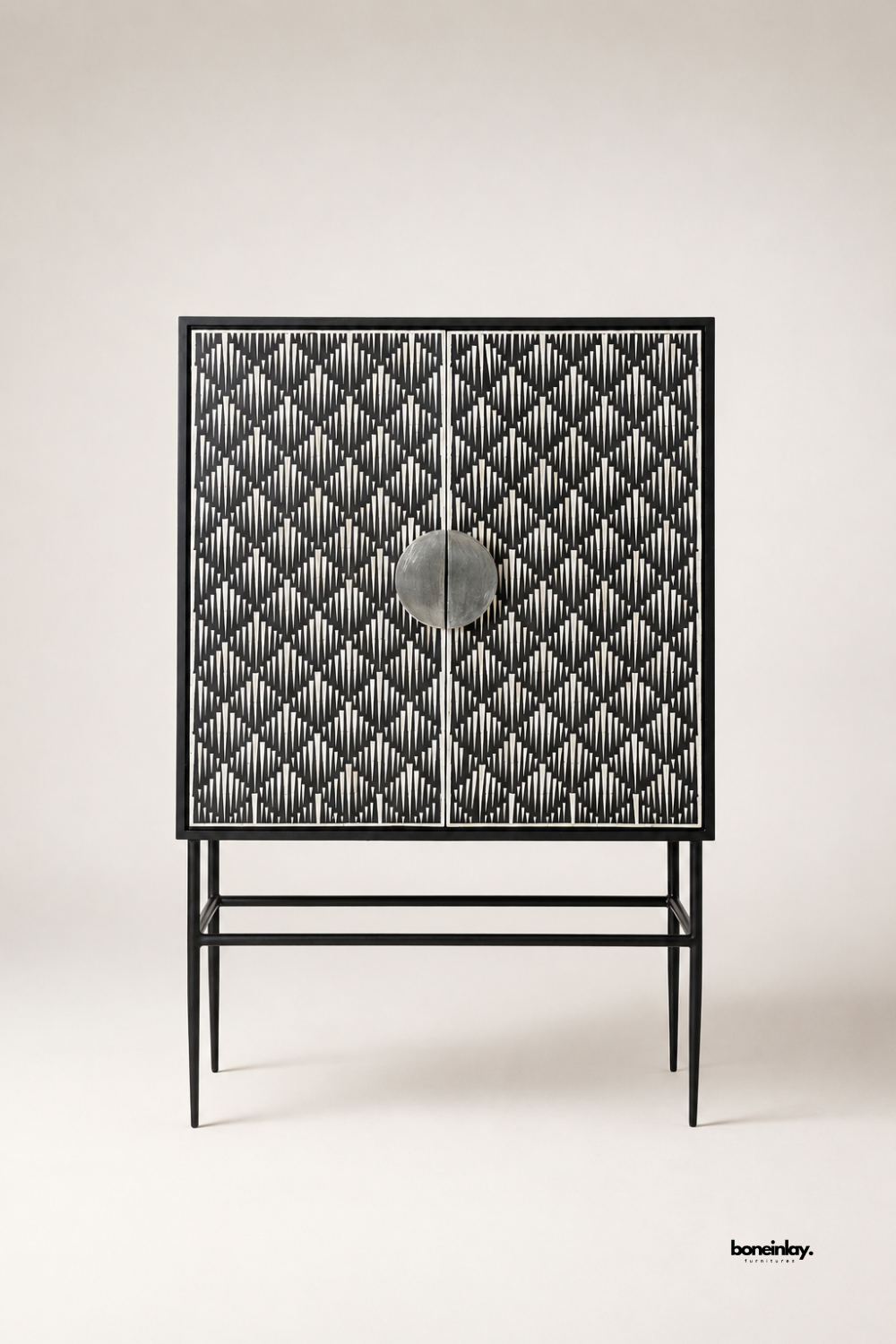 Artisan-crafted black and white bone inlay cabinet showcasing intricate geometric tessellation inlay work across double doors and supported by a minimalist black metal frame. Displayed against a clean neutral background, this modern bar cabinet offers spacious interior storage and bold designer elegance for contemporary interiors.