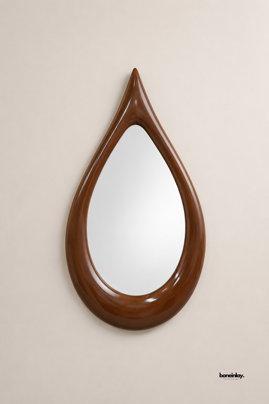 Artisan-crafted teardrop wooden frame mirror showcasing smooth contoured curves and a polished warm walnut finish against a clean backdrop. This unique organic wall accent functions as a striking focal point, perfect for modern entryway, living room, or bedroom vanity spaces.