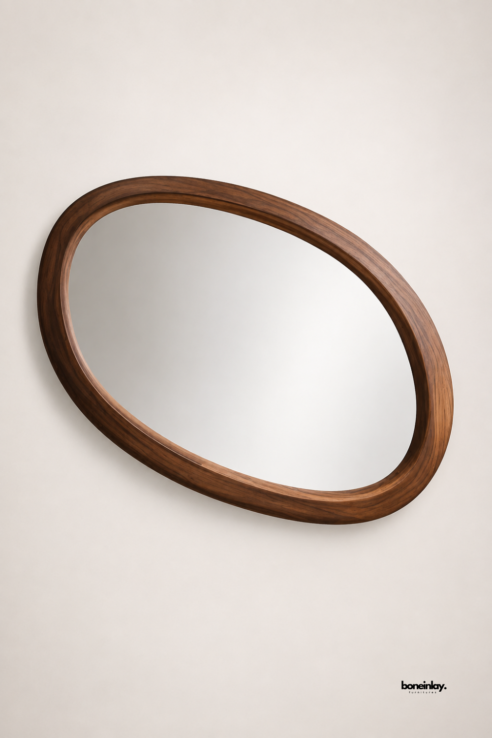 Artisan-crafted solid wooden oval wall mirror featuring a smooth sculpted frame with rich natural walnut graining and gentle asymmetrical curves. Displayed against a clean neutral backdrop, this mid-century modern accent mirror adds organic warmth, elegant simplicity, and functional beauty to contemporary living spaces.