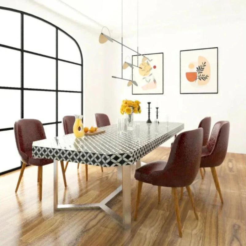 Handcrafted black and white bone inlay rectangular dining table with six upholstered chairs and metallic base in a modern dining room
