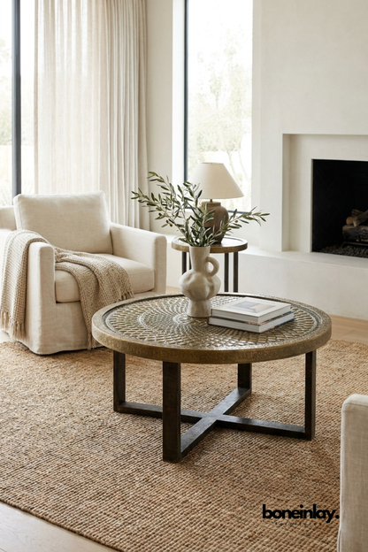 Textured metallic bronze finish round coffee table, artisanal metal living room furniture, luxury rustic modern statement piece .