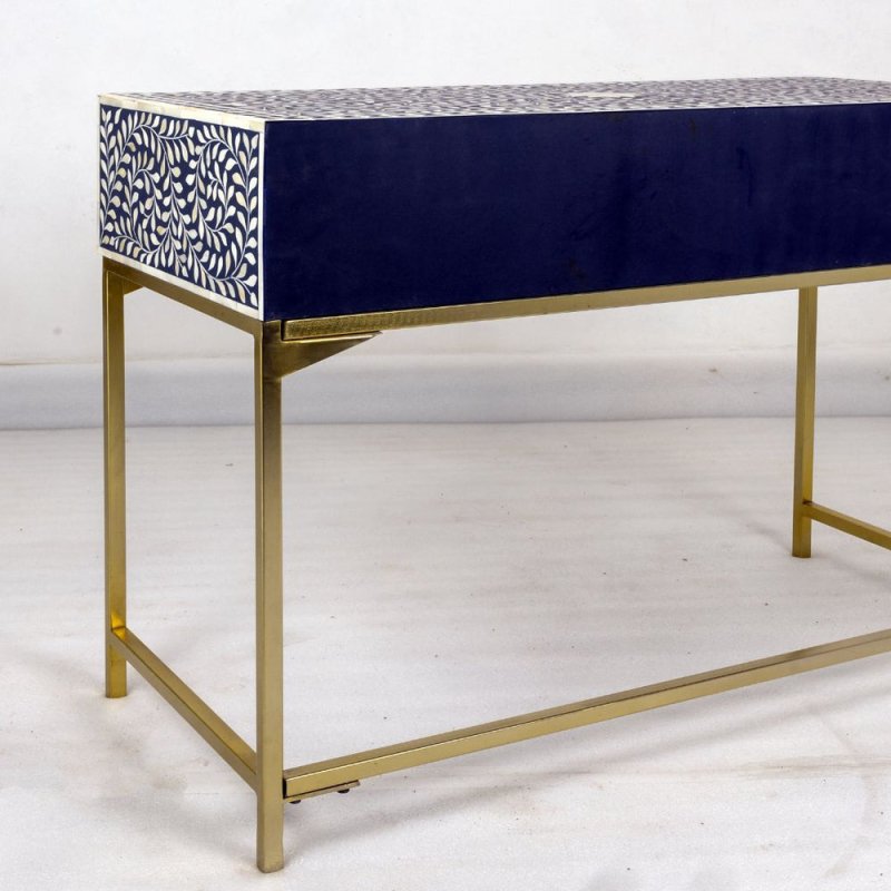 Handcrafted navy blue bone inlay console table showing intricate white floral drawer fronts with brass pull handles — luxury accent furniture