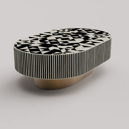 Handcrafted bone inlay oval table showing abstract geometric black white top pattern with striped apron and brass pedestal base