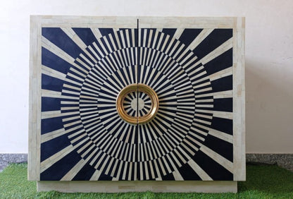 Handcrafted bone inlay bar cabinet with black-and-white radial decoration across its double doors. The patterned front is paired with prominent circular gold-finished handles, creating a high-contrast geometric appearance. Made with solid wood, black resin, and ivory bone inlay, the cabinet offers decorative storage for spirits, glassware, or media essentials.