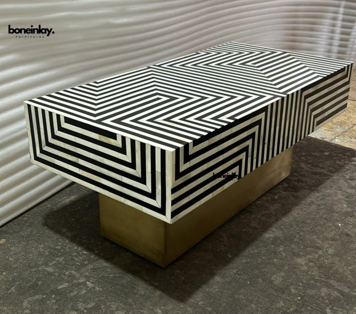 Handcrafted optical illusion bone inlay coffee table featuring bold black and white stripes on a brushed brass base