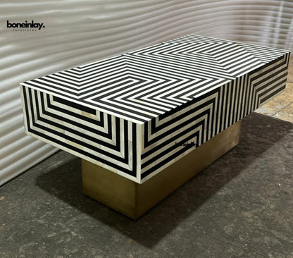 Handcrafted optical illusion bone inlay coffee table featuring bold black and white stripes on a brushed brass base