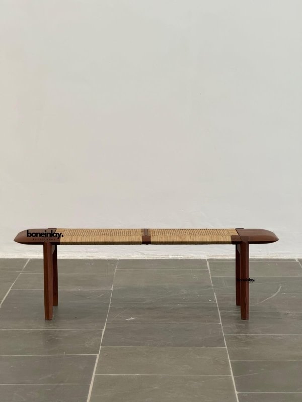 Handcrafted solid teak bench with natural rattan cane seating and a minimalist Scandinavian-inspired design.
