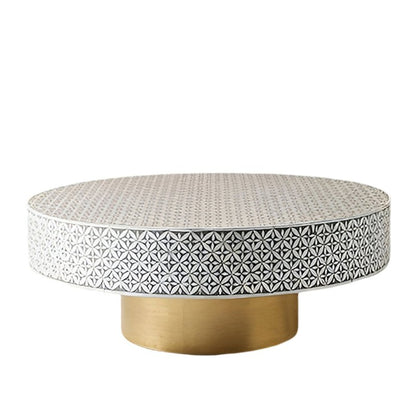 Handmade bone inlay geometric petal pattern circular coffee table with polished brass cylindrical stand on a clean white background, luxury decor