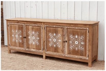 Handmade teak wood inlay four-door sideboard with white bone inlay floral patterns and brass knobs against white plank wall