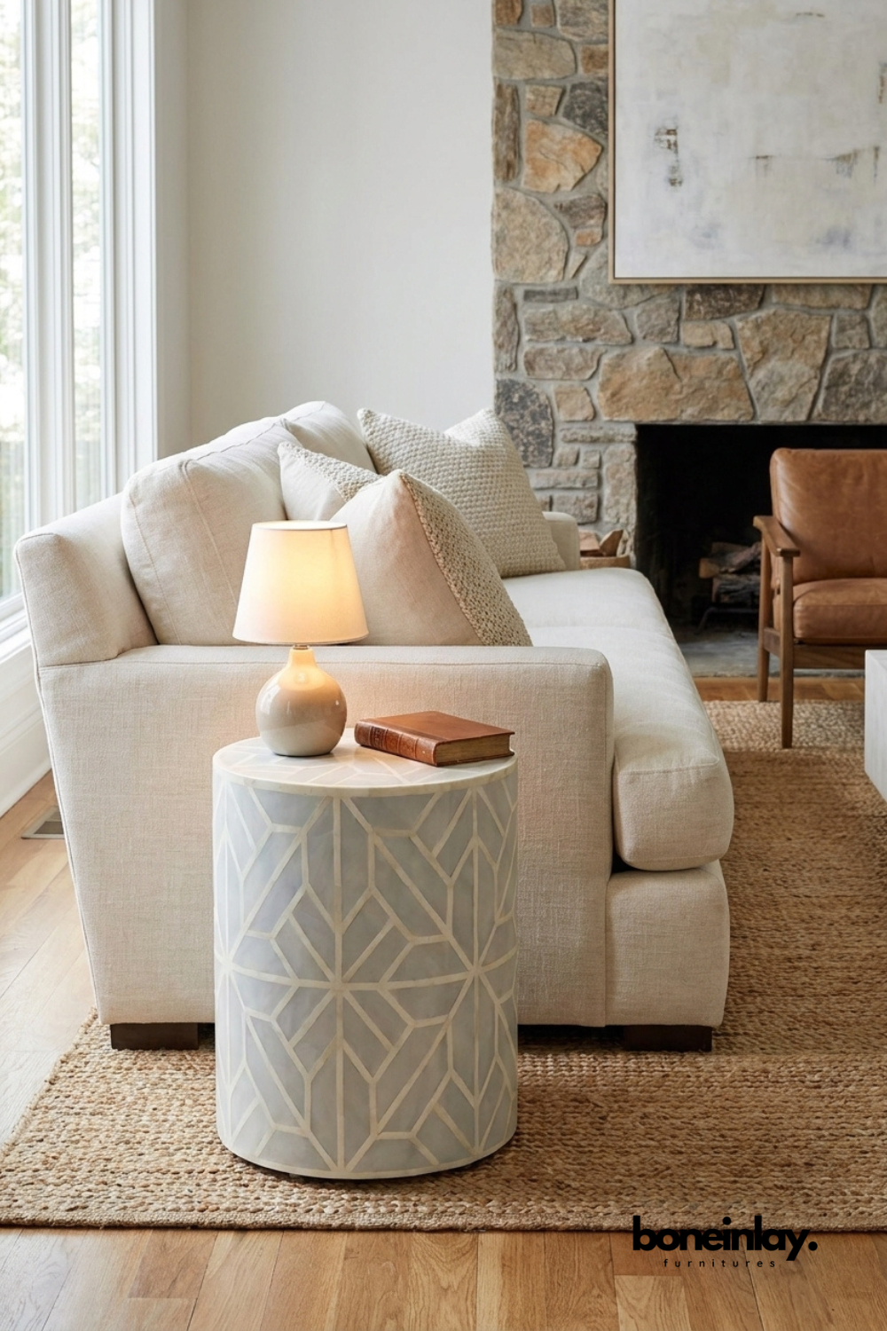Handmade sea green bone inlay drum side table with geometric star pattern styled beside a cream sofa in a modern living room
