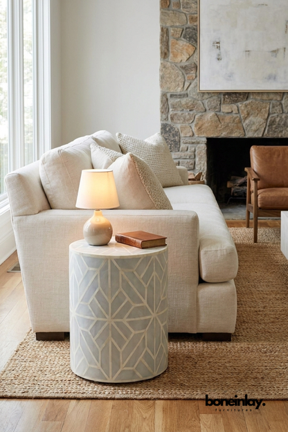 Handmade sea green bone inlay drum side table with geometric star pattern styled beside a cream sofa in a modern living room
