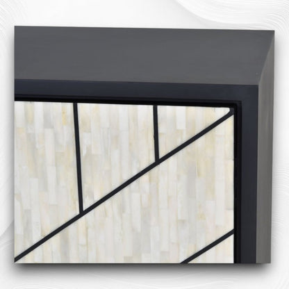Detailed view of hand-laid ivory bone tile inlay on a black mango wood credenza frame, revealing precise geometric line work and fine artisan craftsmanship quality.