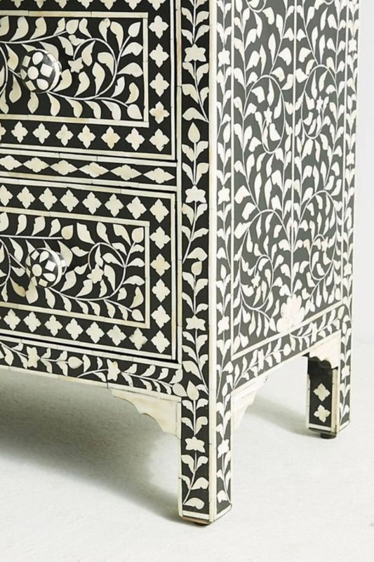 black bone inlay dresser showing dense vine and leaf inlay craftsmanship and ornate foot detail