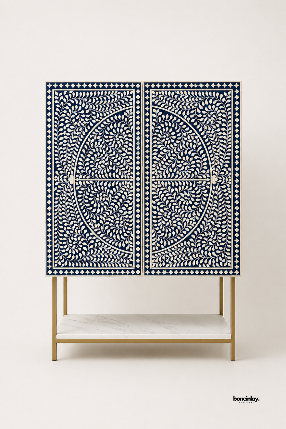 Artisan-crafted tall bar cabinet showcasing double doors with midnight blue floral bone inlay mandala patterns and a brushed gold metal frame with a lower white marble shelf. Displayed against a clean studio background, this luxury storage console delivers bespoke craftsmanship and striking visual symmetry for modern dining and living spaces.