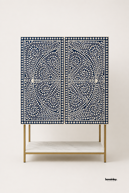 Artisan-crafted tall bar cabinet showcasing double doors with midnight blue floral bone inlay mandala patterns and a brushed gold metal frame with a lower white marble shelf. Displayed against a clean studio background, this luxury storage console delivers bespoke craftsmanship and striking visual symmetry for modern dining and living spaces.