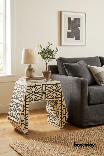 Black and white handmade bone inlay side table with an abstract geometric pattern, trapezoidal silhouette, and contemporary accent-table design.