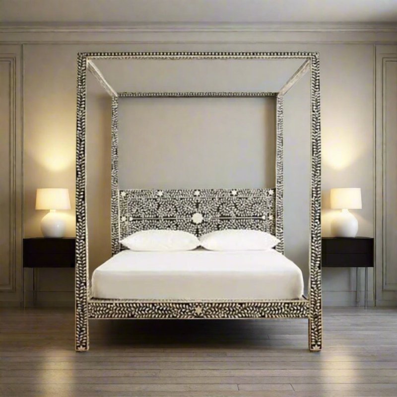Black and ivory floral vine bone inlay canopy four-poster bed handcrafted in solid mango wood, styled in a warmly lit master bedroom with white linen bedding on a hardwood floor.