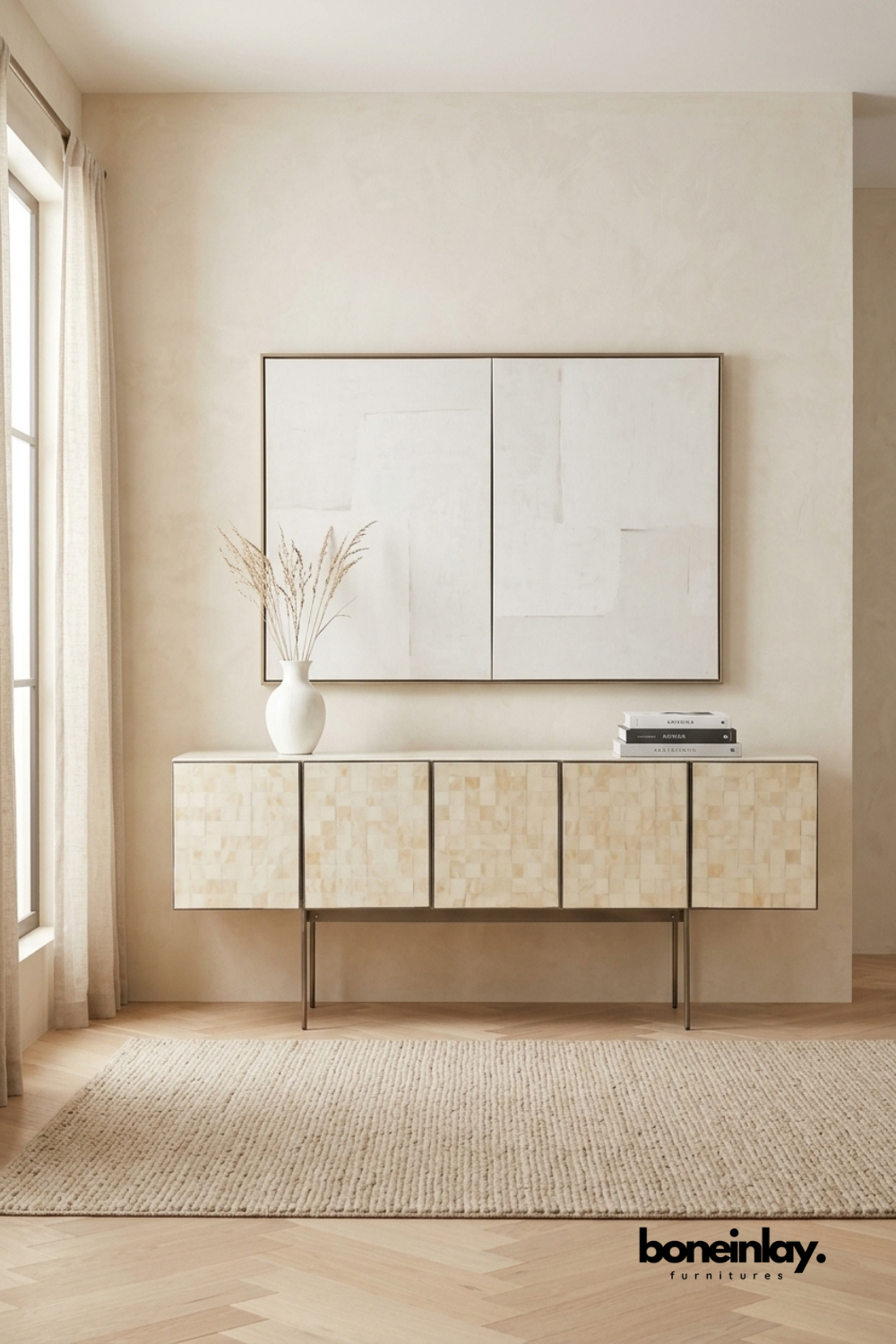 Beige bone inlay sideboard featuring a subtle checkerboard mosaic pattern across five cabinet doors. Supported by slender metal legs for a light, floating appearance in the room. Styled with a ceramic vase, dried pampas grass, and stacked books beneath a two-panel abstract painting. An understated statement piece for minimalist and modern interiors.