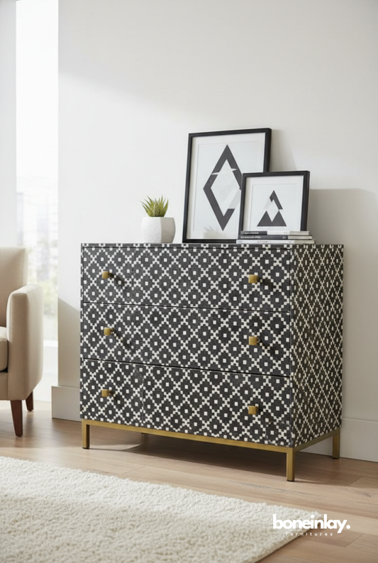Handmade charcoal grey bone inlay chest of drawers with white diamond mosaic pattern, gold brass knobs, and slim metal legs, styled in a modern bedroom setting.