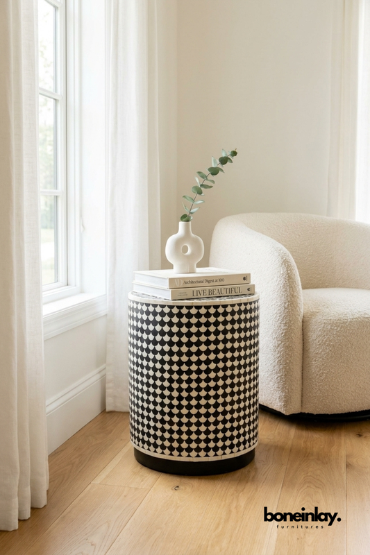 Black  Bone Inlay Drum Stool featuring floral detailing, styled with pampas grass and books against a white shiplap wall in a rustic modern home.