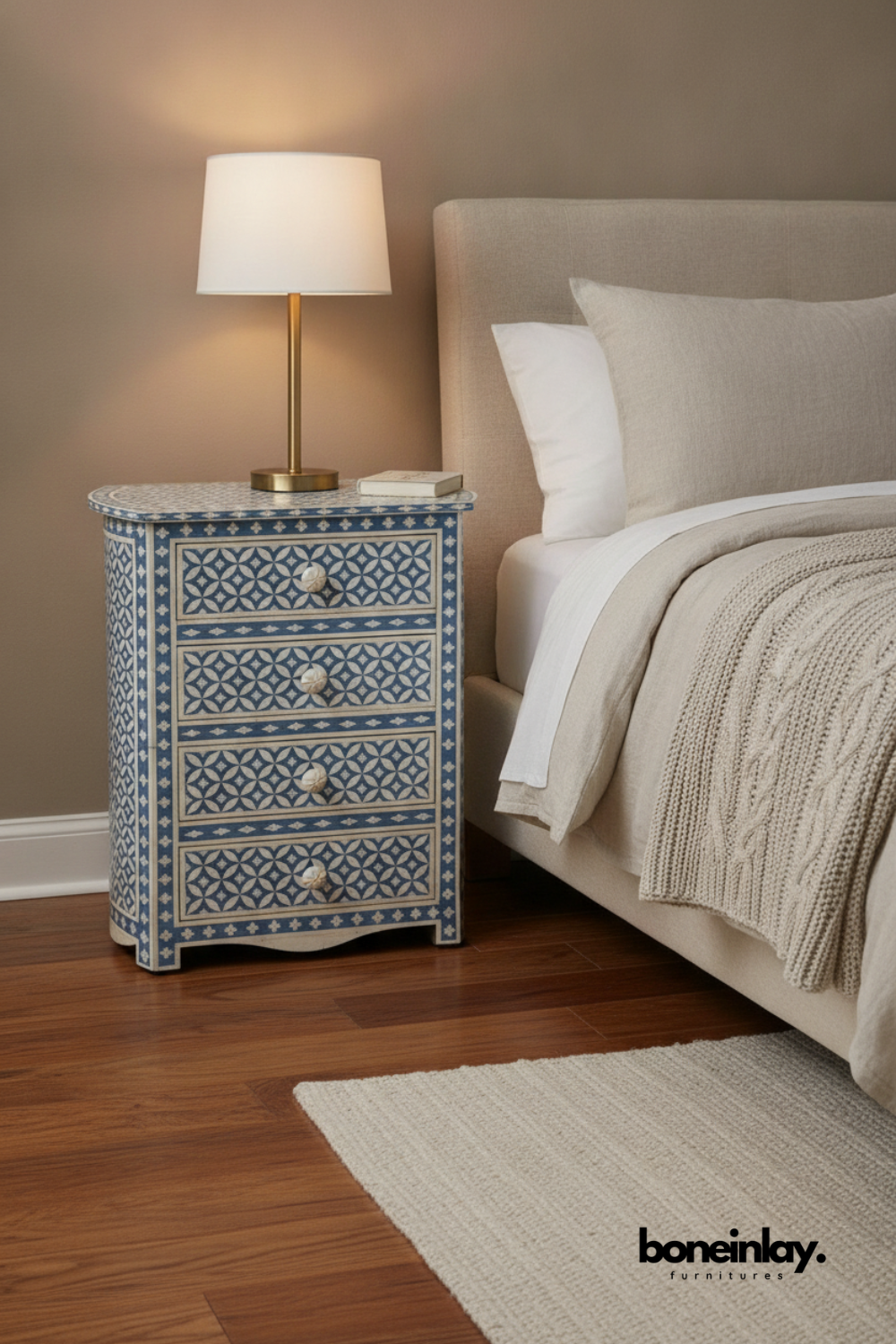 Handmade Bone Inlay Geometric Eye Pattern Nightstand | Lampstand in Blue Color styled in a bedroom setting with a brass lamp on top, showcasing four drawers with carved bone knobs.
