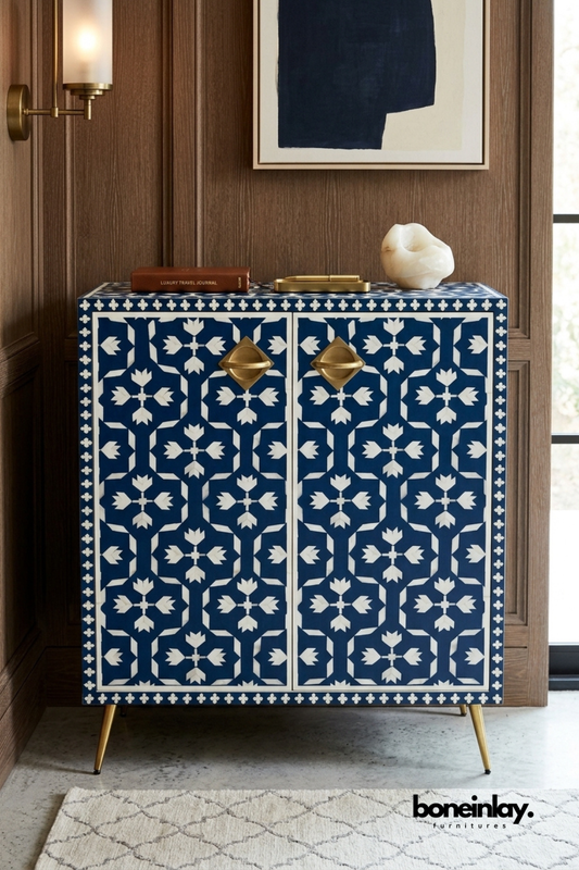 Navy blue and white bone inlay cabinet with a geometric floral pattern.
Two doors feature repeating tulip and cross-shaped inlay motifs.
Diamond-trimmed border and brass diamond pulls add refined detail.
Slim brass legs give the piece a modern, elevated stance.